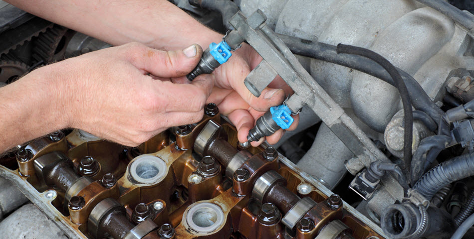 BMW Mechanic Checking Fuel Injector